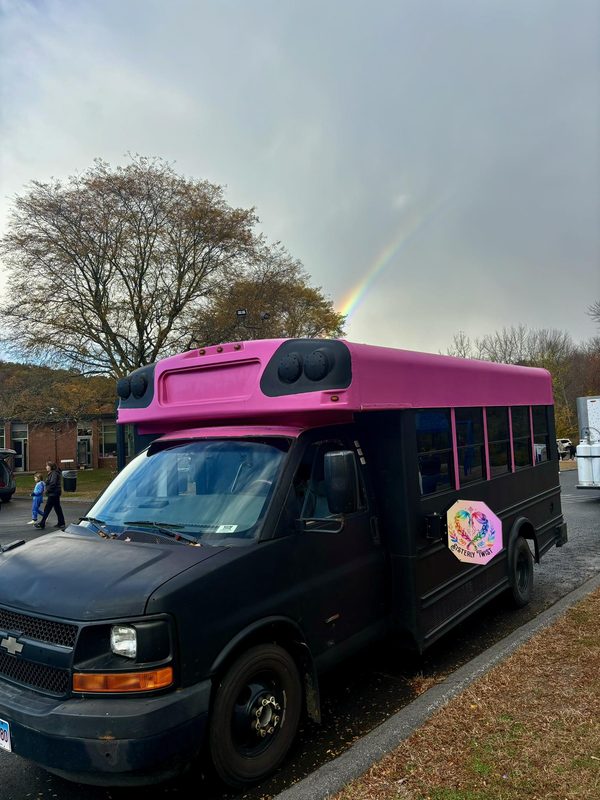 The Double Dutch Bus, a hot pink and black mini bus