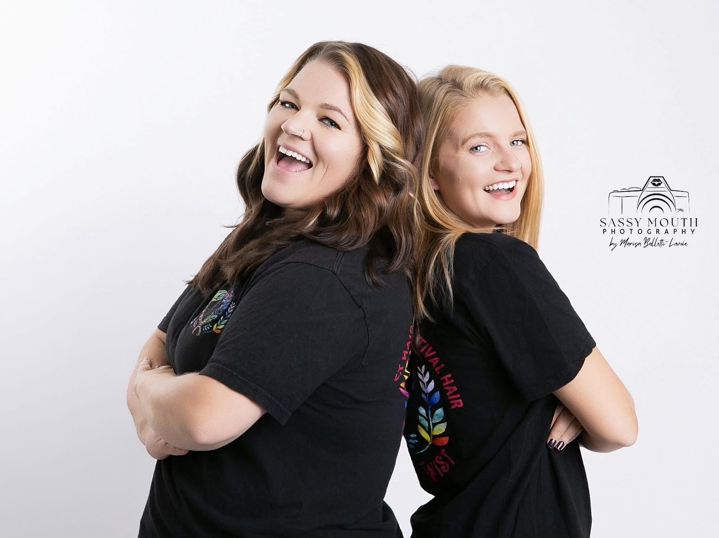 The two sisters behind Sisterly Twist, back to back in Sisterly Twist tees