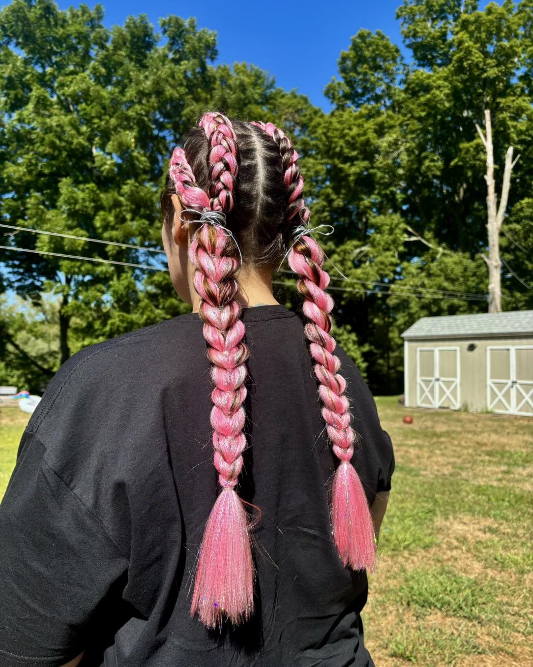 Long pink and white braided extensions in the sunshine