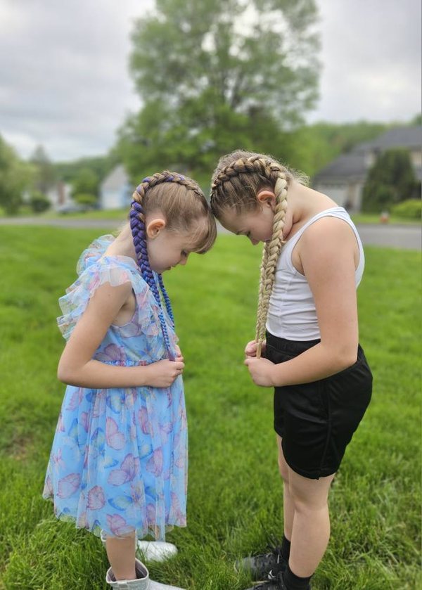 Two girls with matching colored Dutch braids